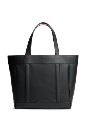 Sac cabas en cuir noir avec deux anses et logo discret de la marque en bas au centre à l'avant, avec un bord rouge et blanc à l'intérieur des anses.