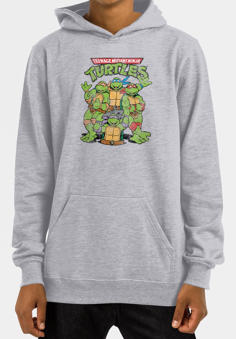 Felpa grigia chiaro realizzata in tessuto morbido, con una grafica colorata di quattro tartarughe del "Teenage Mutant Ninja Turtles" sul fronte.