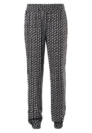 Pantalon de jogging à motif noir et blanc avec ceinture et poignets élastiques, présentant un design abstrait répétitif sur tout le tissu.