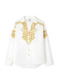 Camicia bianca a maniche lunghe con intricati ricami dorati lungo il collo e le maniche, con chiusura a bottoni e una vestibilità comoda.