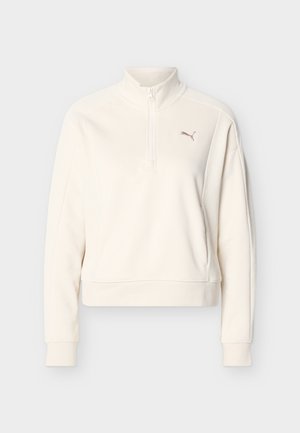 Pullover avorio a maniche lunghe con collo alto, mezza cerniera frontale, polsini a coste e piccolo logo Puma sul petto sinistro.