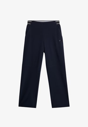 Marineblauwe sportbroek met een wijd beenontwerp, voorzien van zijzakken en een gemusterde elastische tailleband. Glad, lichtgewicht stof.