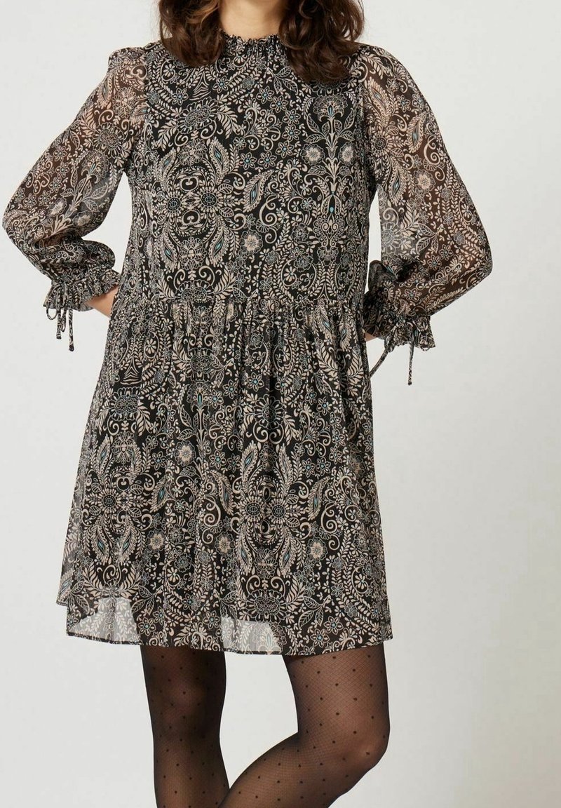 Robe noire à motifs avec manches longues en voile transparent, poignets froncés et col montant. Motifs floraux et cachemire dans des teintes de beige et de bleu sarcelle.