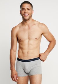 Gray cotton boxer shorts with a navy waistband featuring the brand "ceceba" in white. The shorts have a snug fit and smooth texture.