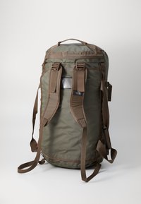 Olive green backpack with brown accents, made from durable fabric. Features adjustable straps, a top handle, and a side pocket.