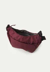 Maroon messenger bag with a zipper closure, adjustable strap, front pocket, and smooth fabric texture. Interior has gray lining.