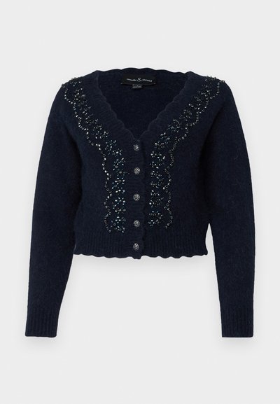 Marineblå cropped cardigan lavet af tekstureret strik, med en bølget udskæring, pyntede knapper og dekorativ perlebehandling langs fronten.