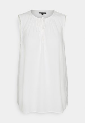 Biała, bezrękawna bluzka z okrągłym dekoltem, wiązaniem z przodu i luźnym krojem.