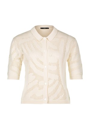 Knit cardigan in cream with short sleeves, button front, and an all-over openwork pattern featuring wave-like designs.