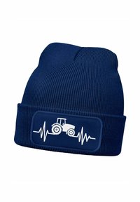 Navy beanie knit hat with a ribbed texture and a white tractor graphic over a heartbeat line displayed on a rectangular patch.