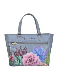 Grijze leren tote bag met kleurrijke bloemen- en cactusontwerpen. Voorzien van dubbele handvatten en een voorzak met rits. Merkenlogo aan de voorkant.