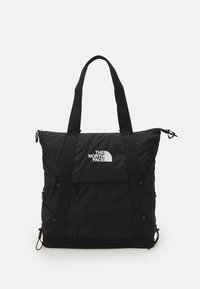 Bolso tote negro hecho de nailon, con forma rectangular, dos asas superiores, logotipo frontal y cuerdas laterales para expansión.