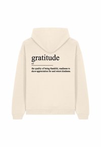 Cream hoodie with a drawstring hood. Back features "gratitude" in large black font, with a definition in smaller print below.