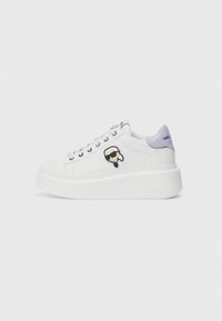 White platform sneakers with a leather upper, featuring a black and white logo patch, silver eyelets, and a lavender heel accent.