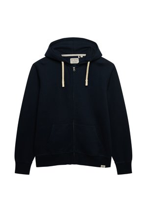 Granatowa bluza z kapturem zapinana na zamek, z kapturem ze sznurkiem, kieszeniami typu kangur i wyszywanym logo. Miękki materiał o gładkiej fakturze oraz żebrowane mankiety.