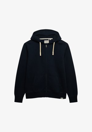 Marineblauwe hoodie met ritssluiting, capuchon met trekkoord, kangoeroezakken en een geborduurd logo. Zachte stof met een gladde textuur en geribbelde boorden.