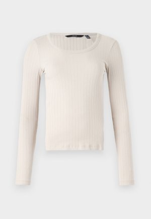 Long-sleeve ribbed top in light beige, featuring a rounded neckline and soft, textured fabric. Regular fit with a straight hem.