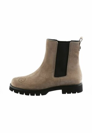 Beige suede Chelsea boot with black elastic side panels, rounded toe, and perforated detail on the toe cap. Thick black rubber sole.