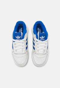 White leather sneakers with blue fabric accents. Features include three blue stripes, perforated toe, and white laces. Adidas logo on tongue.