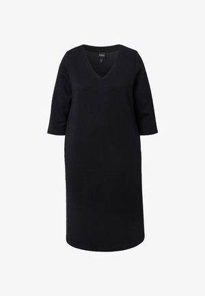 Black dress with a V-neck and three-quarter sleeves. Textured material features geometric patterns. Slightly loose silhouette, knee-length.