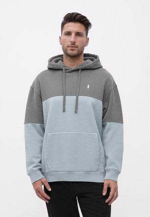 Hooded sweatshirt in gray and light blue. Features a front pocket, drawstrings, and a small tree logo on the chest. Cotton blend fabric.