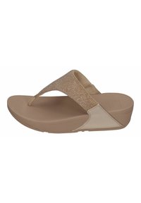 Bež flip-flop sandaal tekstureeritud metallist rihmaga, pehme talla ja kerge kontsaga. Sujuv kummimaterjal minimaalsete aktsentidega.