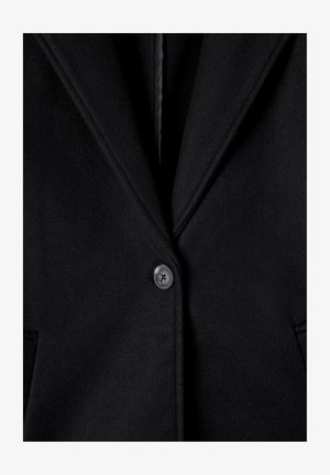 Blazer in lana nera con colletto a punta, chiusura a un bottone e due tasche anteriori. Tessuto liscio e dettagli di design minimalisti.