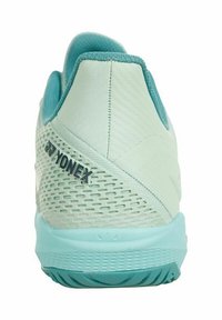 Yonex sports shoe in light mint green with a textured upper, breathable mesh sections, and a flexible aqua sole. Branding on the heel.
