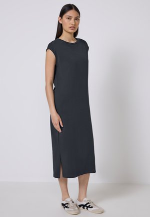 Short-sleeve, dark gray midi dress made of soft fabric, featuring side slits and a relaxed fit, paired with casual sneakers.