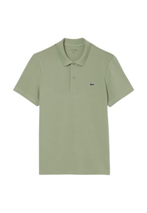 Lichtgroen polo shirt van katoen, met een klassieke kraag, korte mouwen en een klein navy Lacoste logo op de borst.