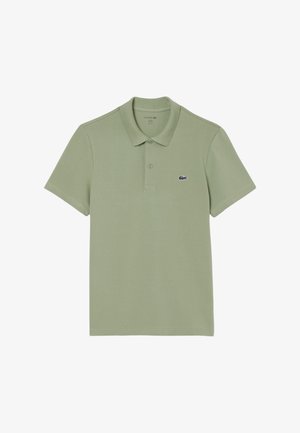 Lichtgroen polo shirt van katoen, met een klassieke kraag, korte mouwen en een klein navy Lacoste logo op de borst.