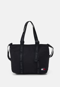 Czarna torba na ramię wykonana z trwałego materiału, z podwójnymi uchwytami u góry oraz paskami z logo "TOMMY JEANS". Zawiera małą naszywkę z logo z przodu.