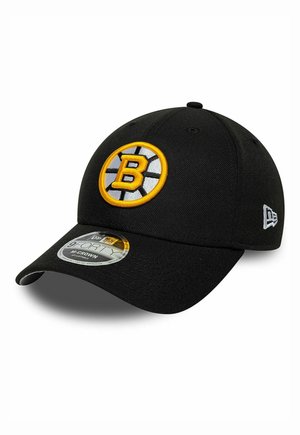 Black New Era 9FORTY adjustable cap with Boston Bruins yellow and white "B" logo and team-colored hockey puck design.