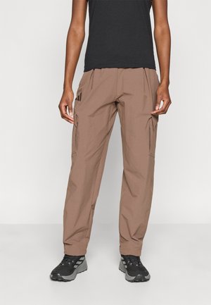 Brown cargo pants featuring side pockets, a relaxed fit, and textured fabric, paired with black athletic shoes on a neutral background.