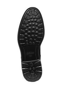 Suola di scarpa in gomma nera con motivi di aderenza testurizzati, design a punta arrotondata e un sistema di ventilazione circolare. Marchio Geox visibile.