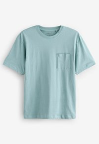 Ljusblå kortärmad t-shirt i bomull. Har en rund halsringning och en bröstficka på vänster sida. Slät yta och avslappnad passform.
