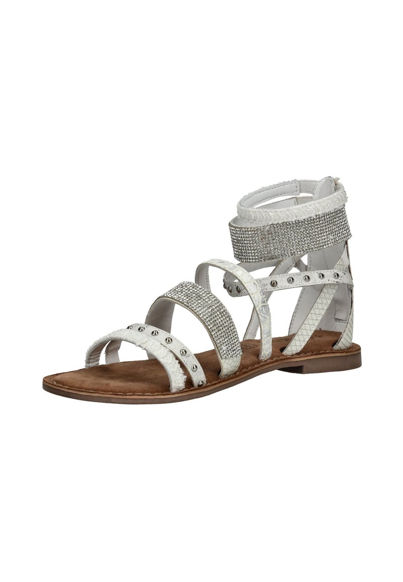 White flat sandal with multiple straps, adorned with silver studs and rhinestones, and a zip closure at the back.