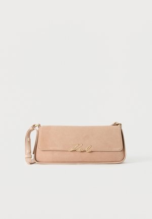 Beige rektangulær skuldertaske med justerbar rem og guld "Karl"-logo på frontklappen, sat mod en ensfarvet hvid baggrund.