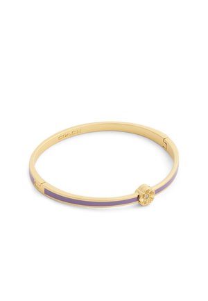 Bracelet jonc en or avec incrustation d'émail lavande et fermoir en forme de soleil orné d'une petite pierre précieuse transparente.