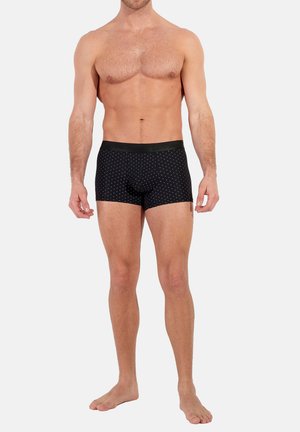 Boxer aderenti neri con pois bianchi, dotati di una vita nera uniforme. Realizzati in un materiale elastico e liscio per garantire comfort.