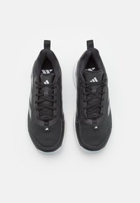 Black athletic shoes with mesh upper, lace-up design, white accents, and textured surfaces. Features a rubber sole and rear loops for easy wear.