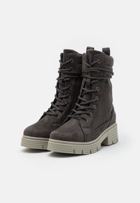 Gray suede ankle boots with a thick, textured sole, lace-up front, and folded cuff detail. Durable design for outdoor wear.