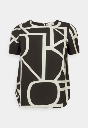 Short-sleeve top in black fabric featuring a bold white geometric pattern. Round neckline with a subtle back closure detail.