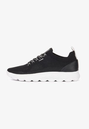 Black sneaker with a breathable mesh upper, white cushioned sole, and textured details. Features black laces with reflective accents.