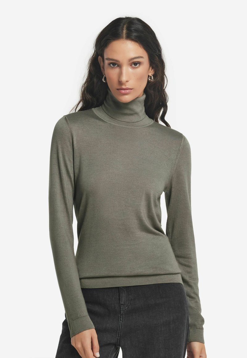 Grön polotröja tillverkad av mjukt material, med långa ärmar och en figurnära design, samt ribbat krage och fåll.