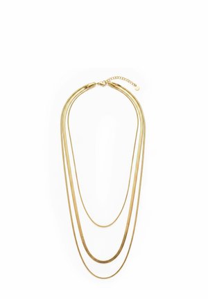 Three-layered gold necklace with fine chains and lobster clasp on a white background.