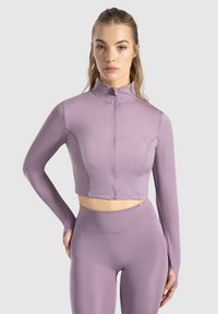 Lilla cropped zip-up jakke med lange ærmer, lavet af glat, strækbart stof. Sammen med matchende high-waisted leggings.