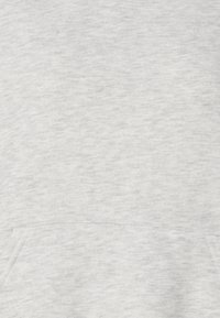 Helehall sweatshirt sileda tekstuuriga, millel on eesmine tasku ja lihtne disain. Kangas näeb välja pehme ja mugav.
