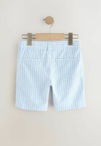 Ljust blå shorts med vertikala vita ränder, tillverkade av mjukt tyg. Har två bakfickor och en slät midja.