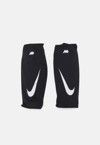 Sorte atletiske ærmer lavet af mesh-stof, med hvidt Nike-logo og swoosh-design, samt elastiske åbninger.